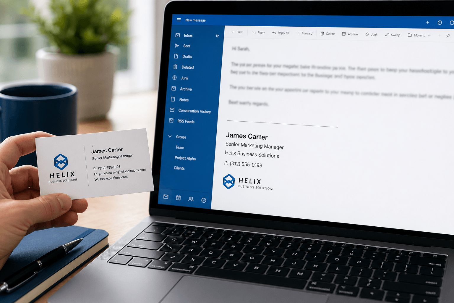 Professional email signature displayed on a laptop screen next to a business card