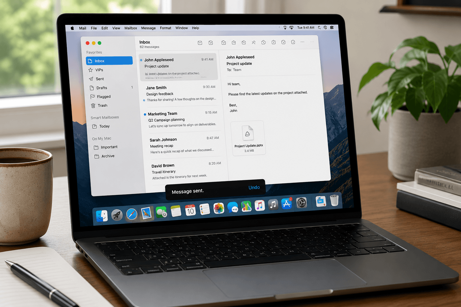 Apple Mail open on MacBook showing inbox with organized email threads